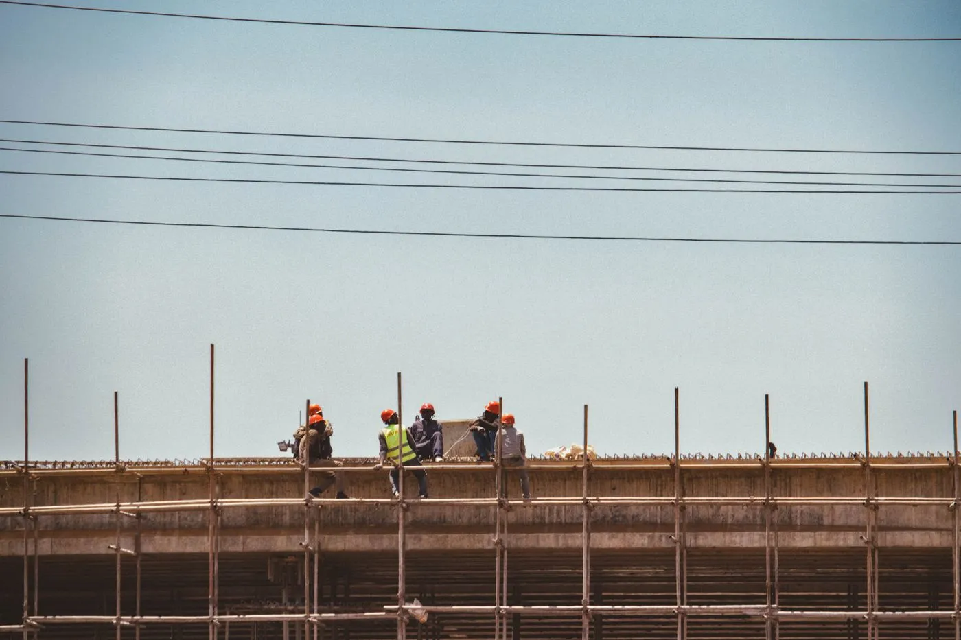 Construction workers on scaffolding at a building site