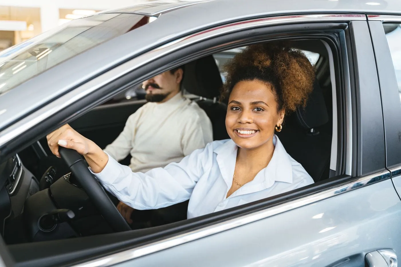 A new driver collecting the keys to her car